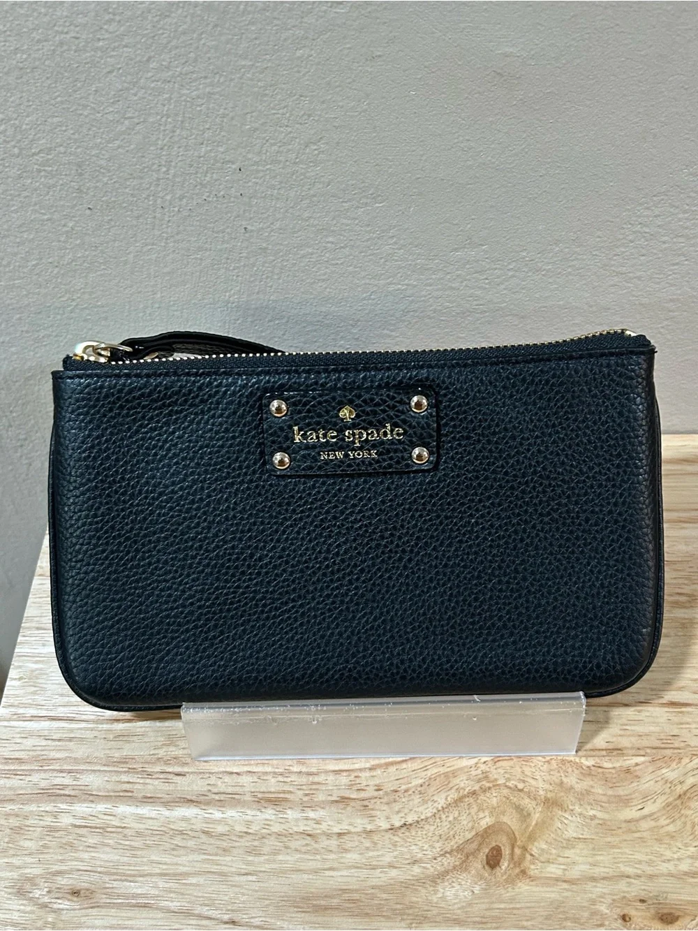 kate spade black pebbled leather wristlet with gold-tone logo